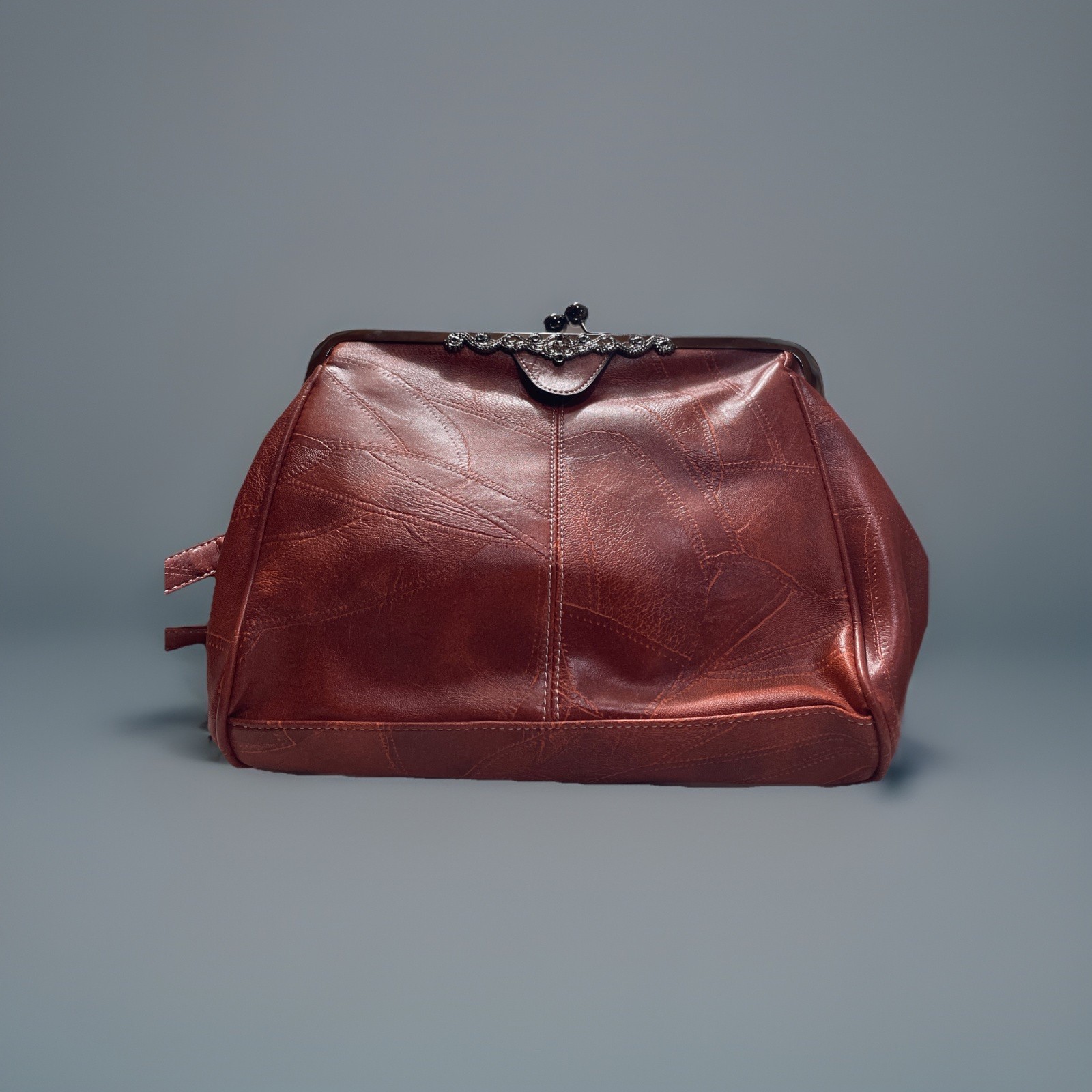 leather handbag with kisslock frame