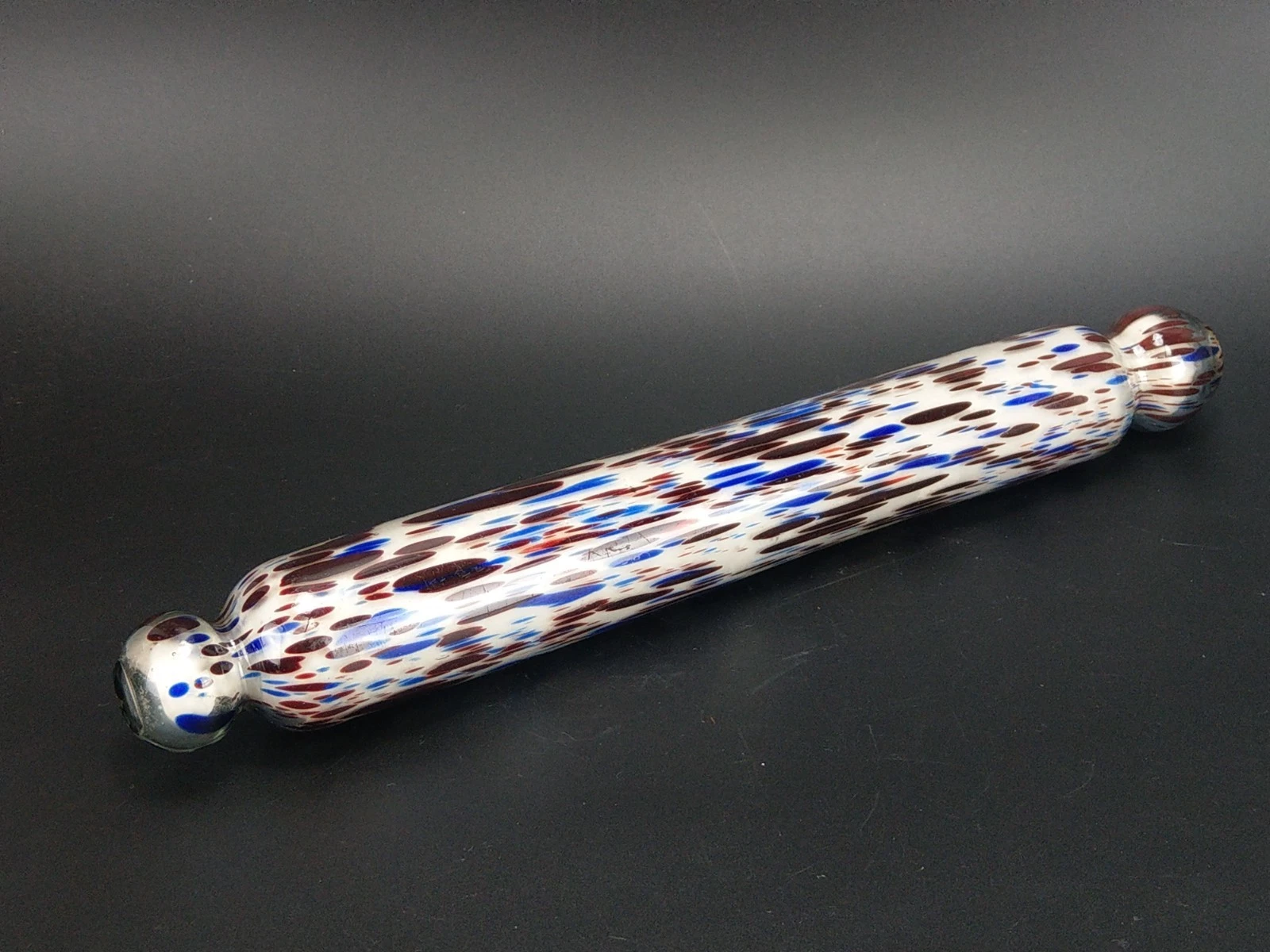 Antique rolling pin in blue and blood red splatter Nailsea glass plaster filled