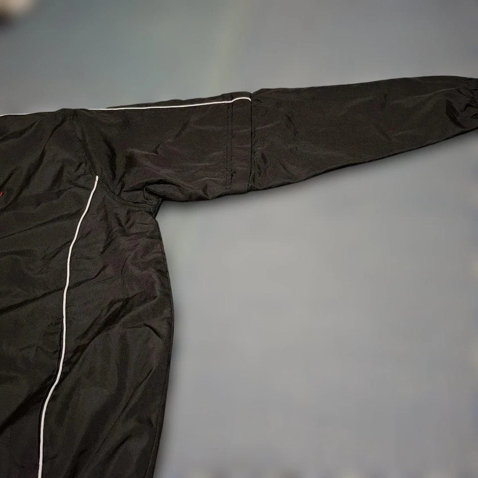 Chaqueta de golf Srixon negra de manga larga con mangas desmontables, líneas laterales blancas Foto 3 de 4