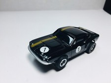 JOHNNY LIGHTNING MUSTANG Fastback BLACK/GOLD  AW chas  case AURORA AFX NEW