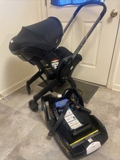 Doona Infant Car Seat  Stroller Combo Black, Rear Facing, Sun Canopy  Car Base