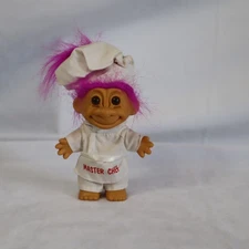 Vintage Troll Doll 4 inches tall with bright pink hair and "master chef" outfit