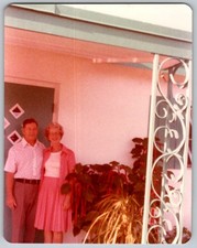 Vtg Color Snapshot Smiling Older Couple On Porch Pink Dress Wrought Iron Post