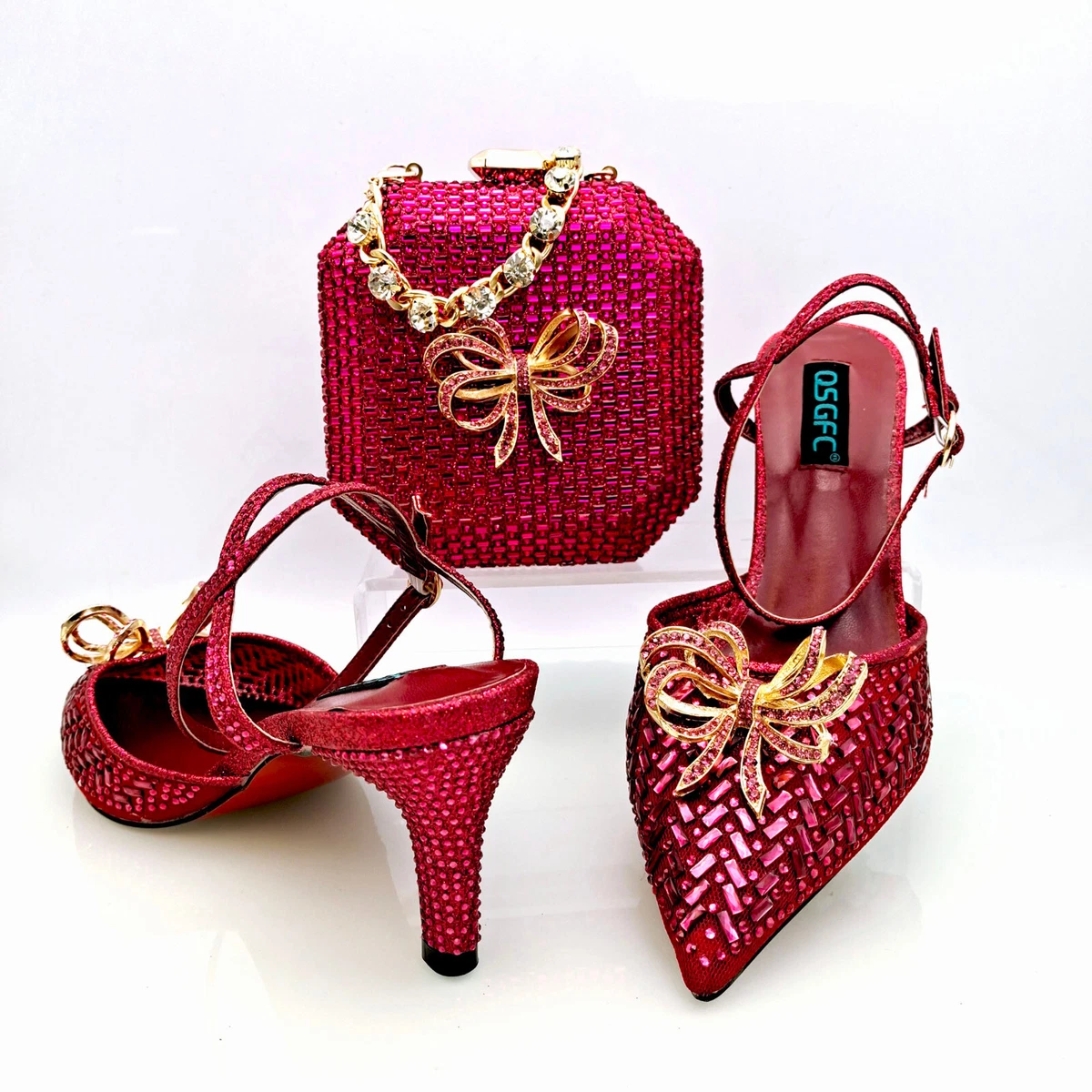 Dark and light pink bag, shoes and purse with a decorative bow in the shape  of