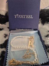 Yoosteel handmade pearl necklace features a gold initial pendant Letter A