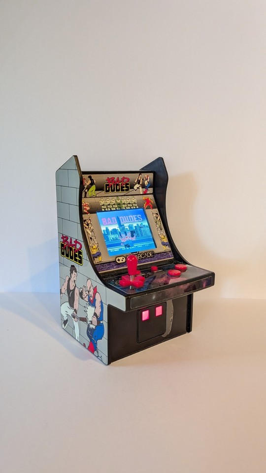 A desktop-sized Bad Dudes arcade cabinet that plays the actual 1988 brawler — a retro gaming flex that doubles as a conversation-starting desk ornament.