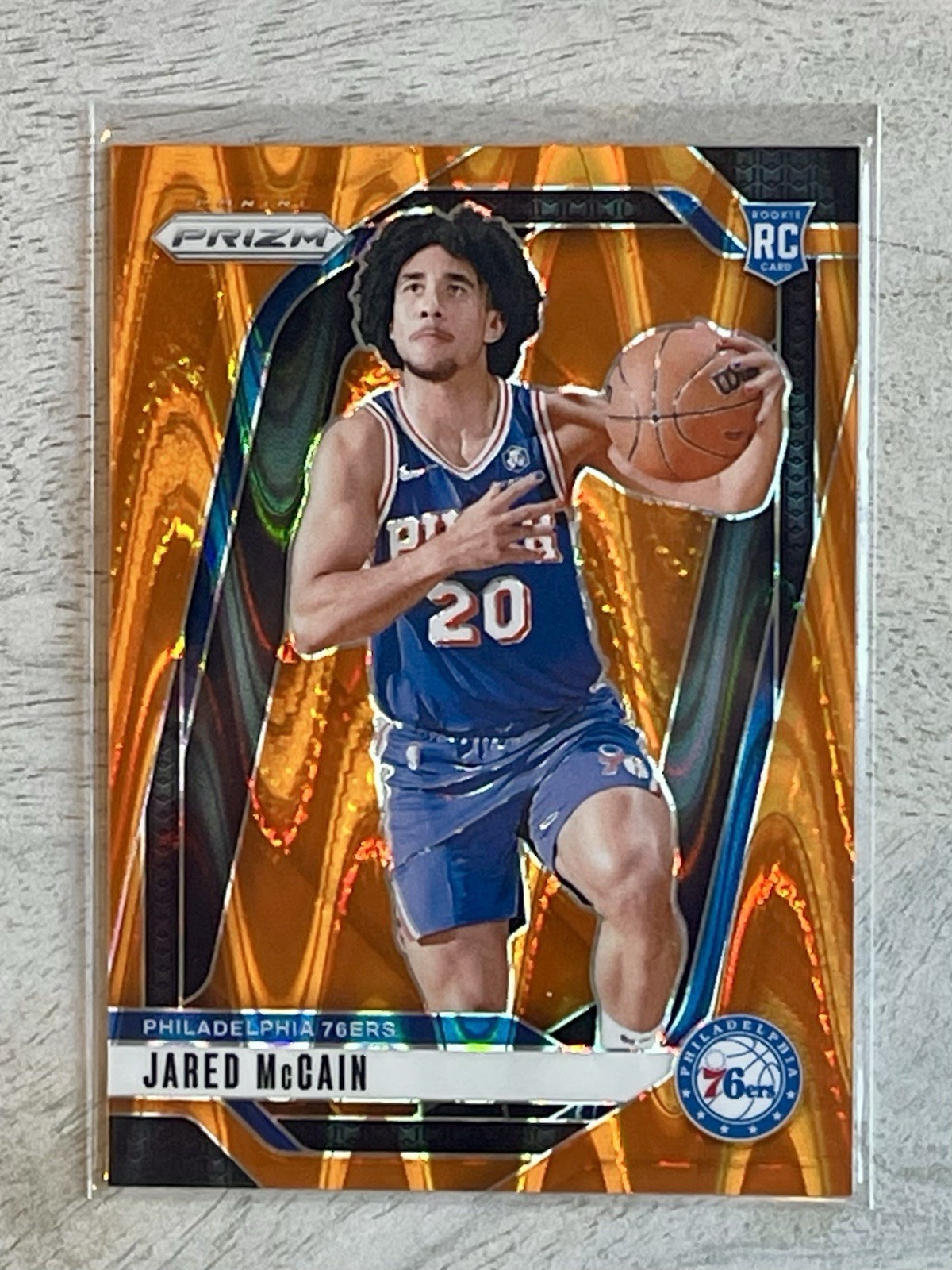 Jared McCain 2024-25 Prizm Orange Seismic Rookie 17/199 #222 76ers