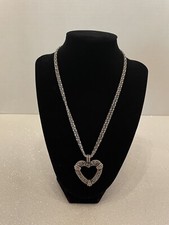 A woman  s heart shaped pendant and chain necklace