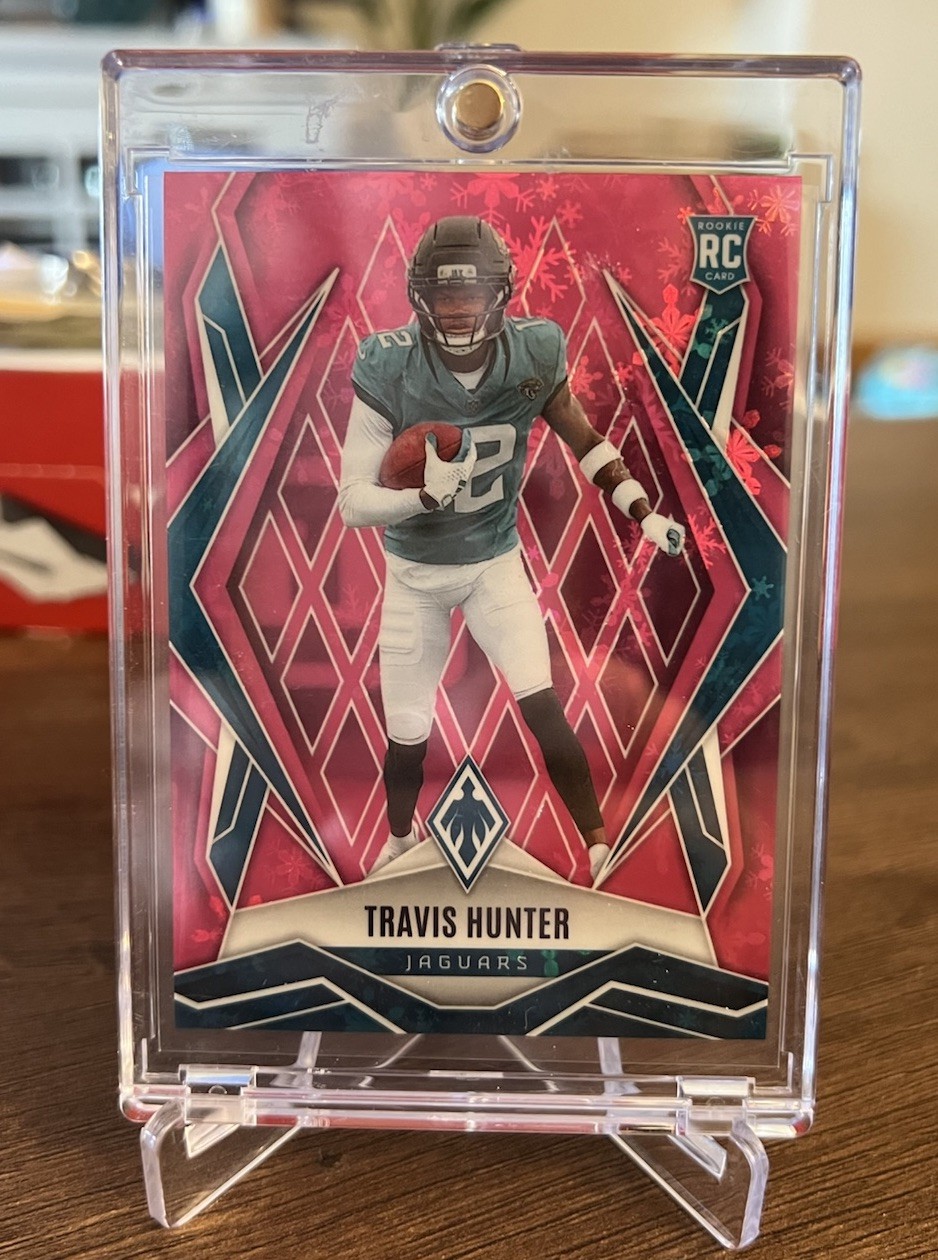 2025 Panini Phoenix - Rookies Travis Hunter #157 Pink Winter /299 (RC)