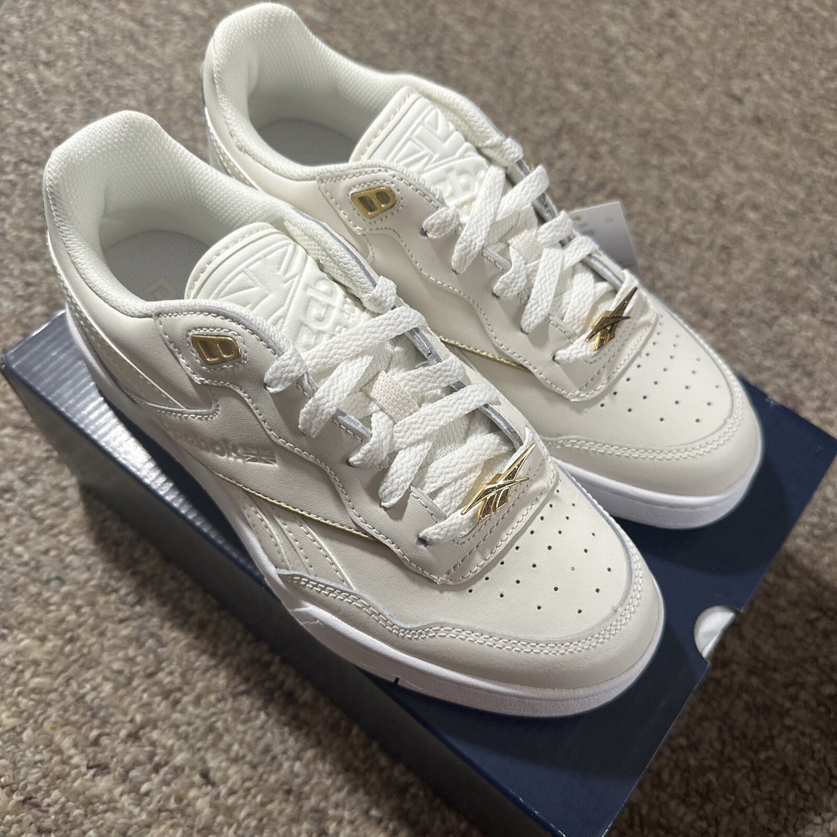 gold and white reebok