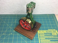 Vintage Stuart 10V steam engine, on base with cover, brass clad flywheel