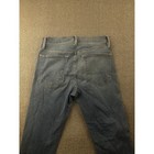 Back view of Frame Jeans women 25 with frayed hems, two pockets, and belt loops on beige fabric surface.