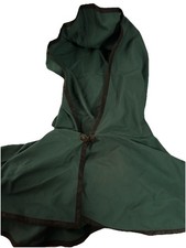 green hooded cloak with trim and a decorative clasp closure.