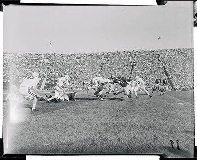 Michigan's Terry Barr stops Minnesota's quarterback Don Swanson as- Old Photo