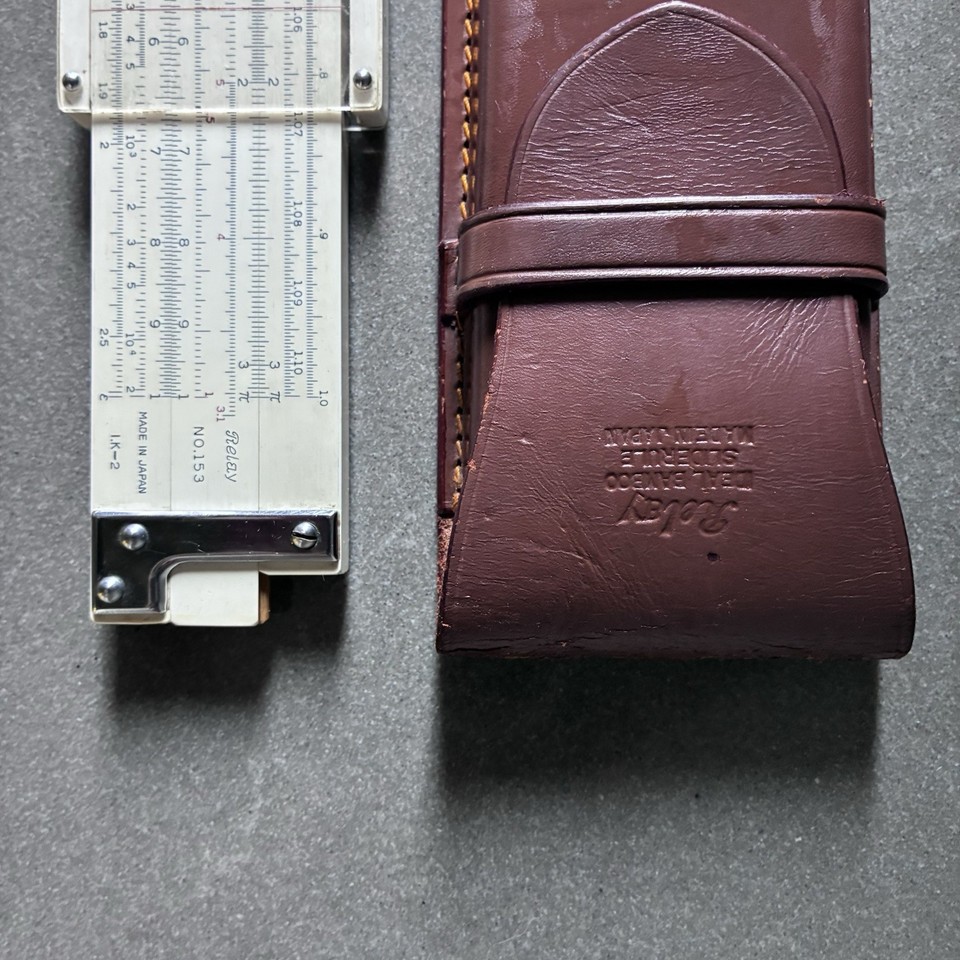 A bamboo Japanese slide rule in its original leather case — rarer than the aluminum American versions and strikingly beautiful as both a tool and an artifact.