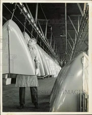 1946 Press Photo Workman boosts hood onto conveyor at Studebaker Assembly Plant