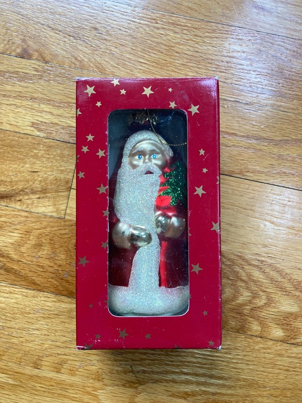 Santa Ornament in Red Robe and Gloves Holding Christmas Tree