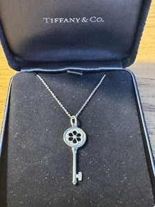 Tiffany&co 18k gold and diamonds Daisy  key charm and chain.
