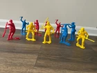 Vintage lot of 10 large plastic frontier figures, mixed poses, bright colors.