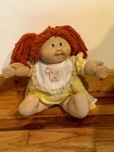 Cabbage Patch Kid- Doll with red hair, green eyes, one dimple. Vintage 1978/1982