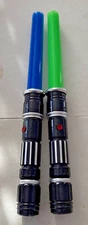 Two Lesuter Toys Retractable Electric Light-Up Laser Swords.
