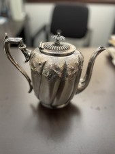 An ornate, fluted, silver teapot by Joseph Rodgers & Sons, Sheffield.