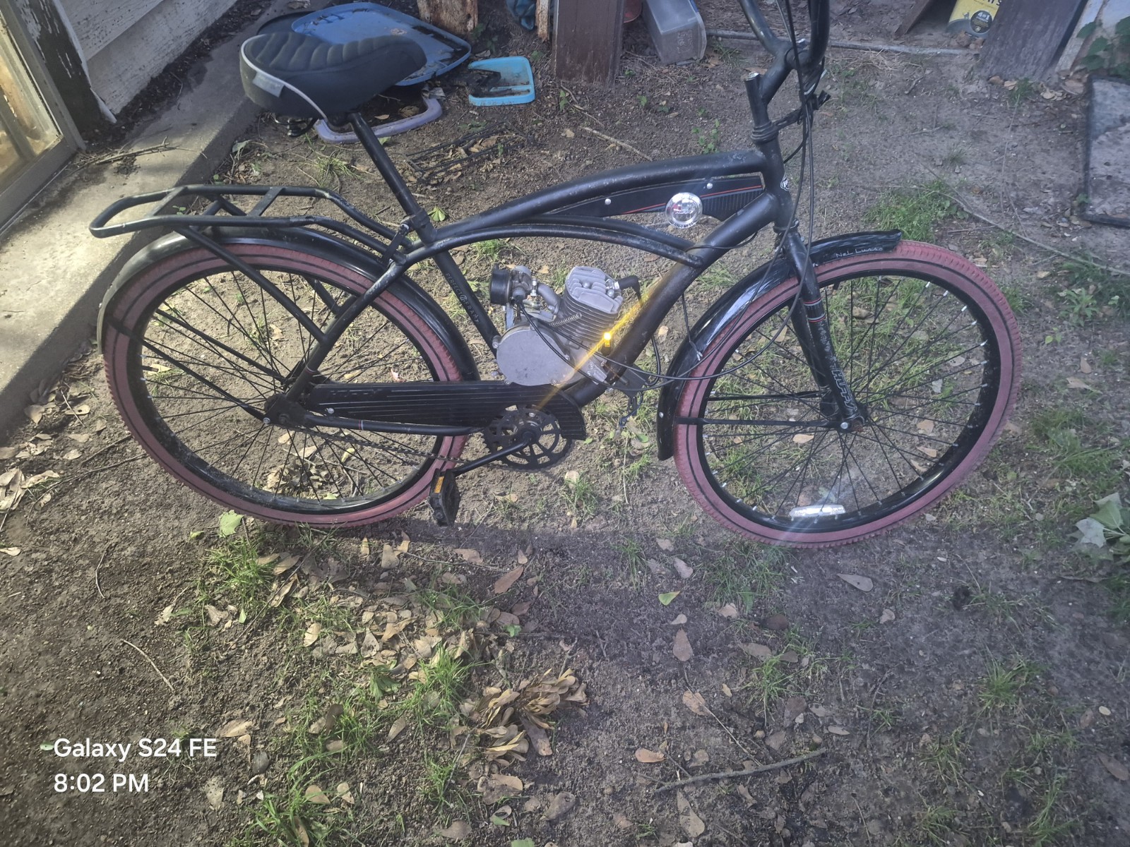 Huffy Nel Lusso 26-inch cruiser with a small motor.
