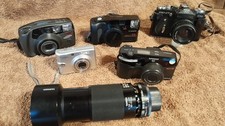 Five Quality Cameras and Zoom Lens, One Digital and 4, 35mm Film Cameras.