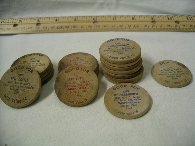 18 McDonald's Wooden Nickels and 2 McDonald Senior Customer Coupon Covers.