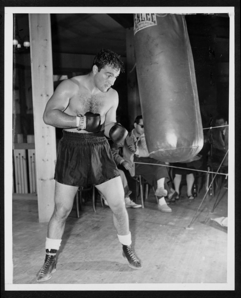LEGENDARY BOXING CHAMPION ROCKY MARCIANO WORKS THE BAG !!!!! 8X10 - Main Image