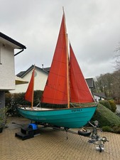 A  traditional "Swallows and Amazon" Drascombe Lugger sailing dinghy and trailer