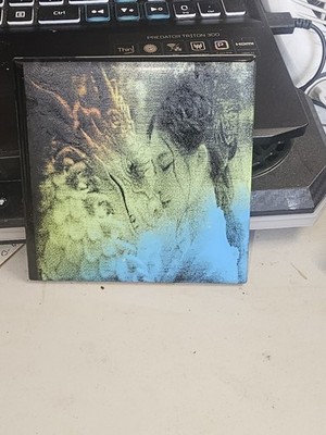 SB Ceramic with dragon and a woman engraved on it 4x4 inches.