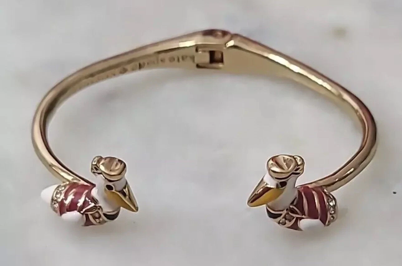 Bracciale Kate Spade New York tono oro prendere volo pellicano cerniera aperta braccialetto