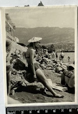 Pretty young woman in swimsuit Bikini and panama on the beach Old photo