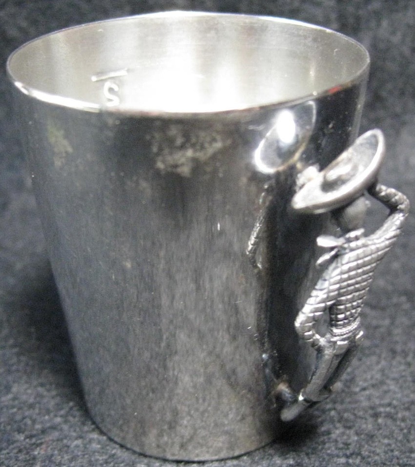 A silverplated Napier jigger with a genuine cowboy-boot handle — the kind of barware artifact that stops a cocktail party cold.