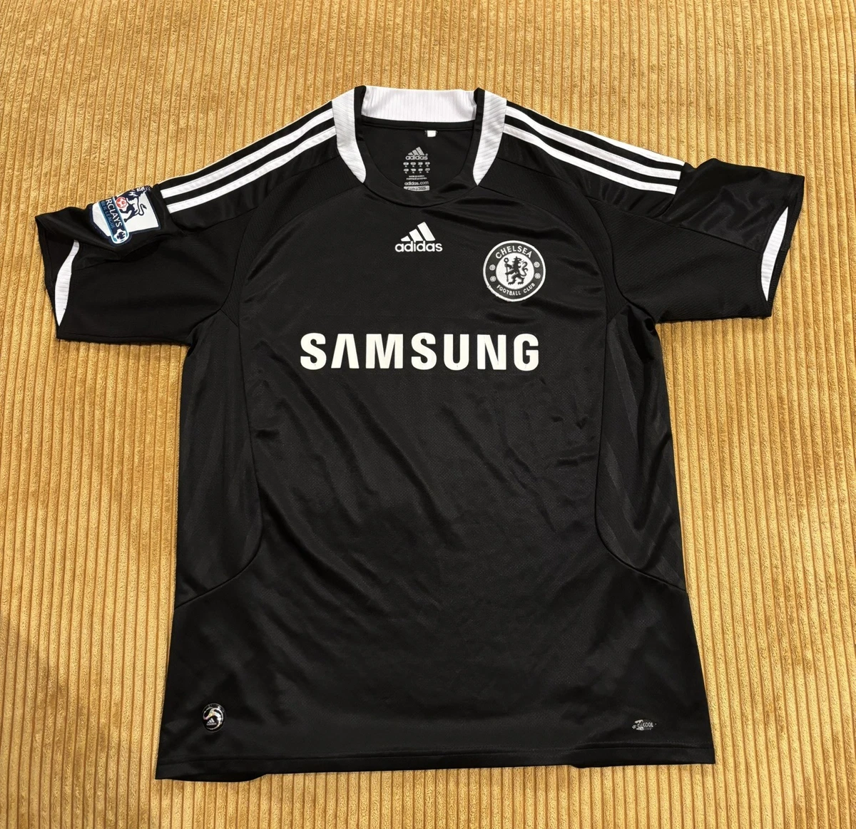 Preços baixos em Chelsea Preto International Club Camisas de