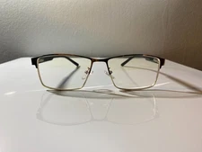 Unisex, academic style eyeglasses with black & gold frame and clear lenses.