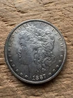 1887 P Morgan Silver Dollar. Estimated Uncirculated Toned Au-Unc rb18