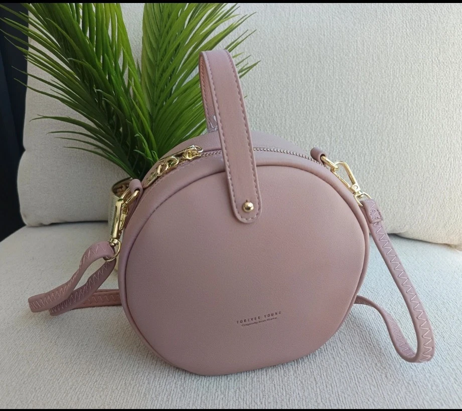Sac bandoulière femme rond rose similicuir uni fermeture éclair doré - Photo 1/4
