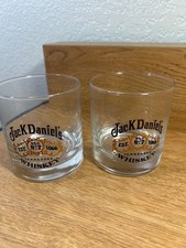 Jack Daniel's Old No. 7 whiskey glass featuring a black and gold logo