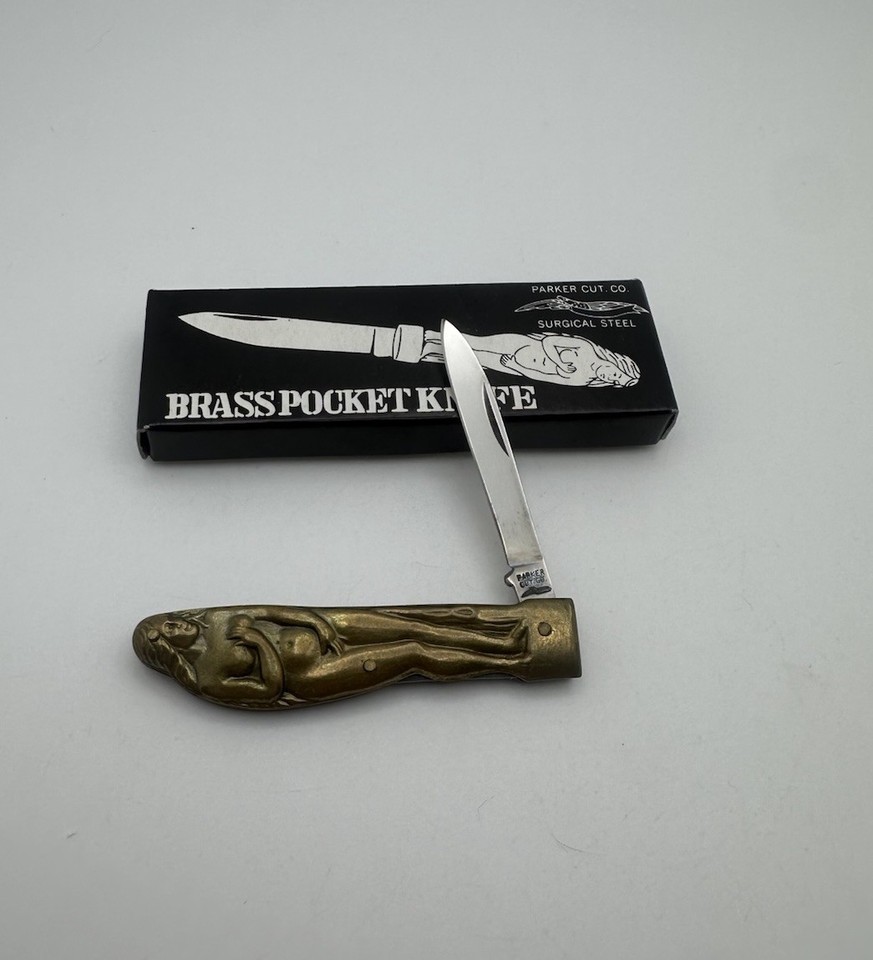 Tiny brass pocket knife with a sculpted nude lady handle — a genuine vintage Japan novelty that's equal parts cheeky and collectible.
