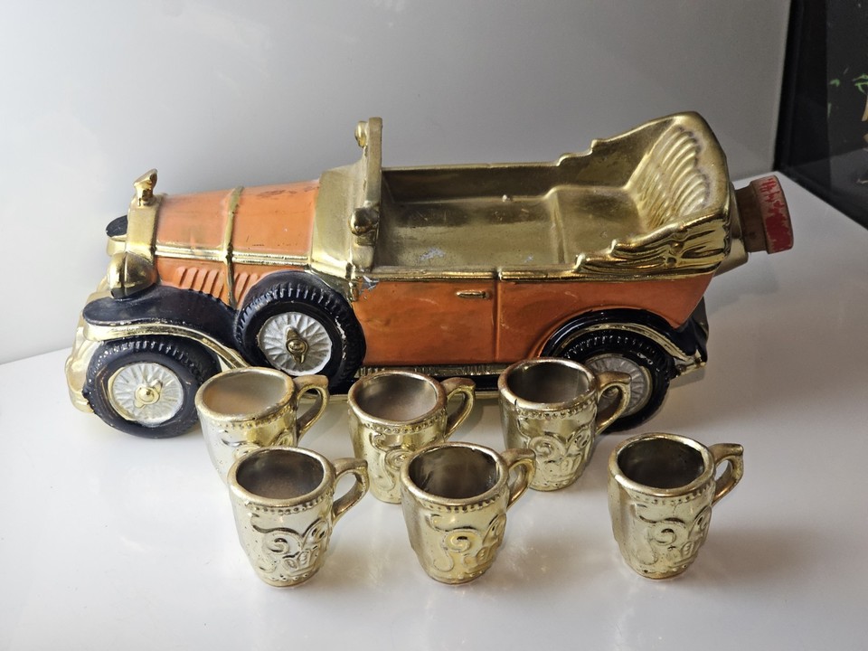A hand-painted vintage Japanese car-shaped whiskey decanter with 6 shot glasses — a bonkers, brilliant piece of kitsch that whiskey and car lovers will obsess over.