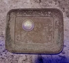 old metal tray with  Morgan Silver dollar emblem
