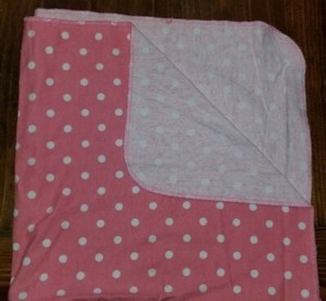 pink blanket with white polka dots
