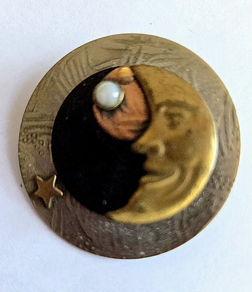 A handcrafted mixed-metal Man in the Moon brooch combining brass, copper, and mother of pearl — the kind of wearable art you'd find in a serious vintage jewelry collector's cabinet.