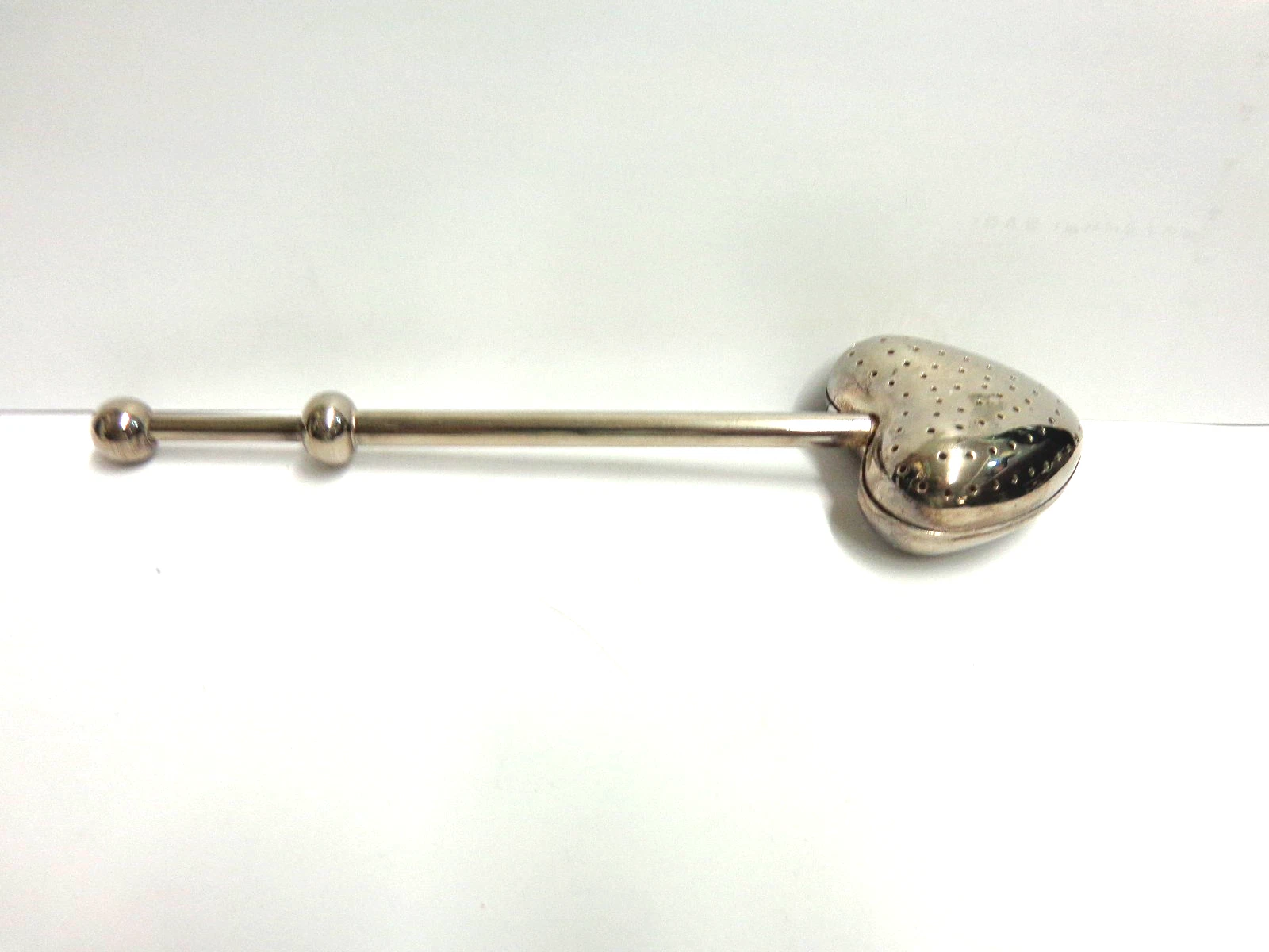 silver plated tea infuser heart shaped push hdle sz 7in lg wgt 56.1 grams