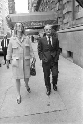 Truman Capote walking with an unidentified woman past The Colony R- Old Photo
