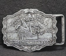 XC25133 VINTAGE 1970s LIVINGSTON WELLS CO. FOREIGN GOLD DEALERS BELT BUCKLE