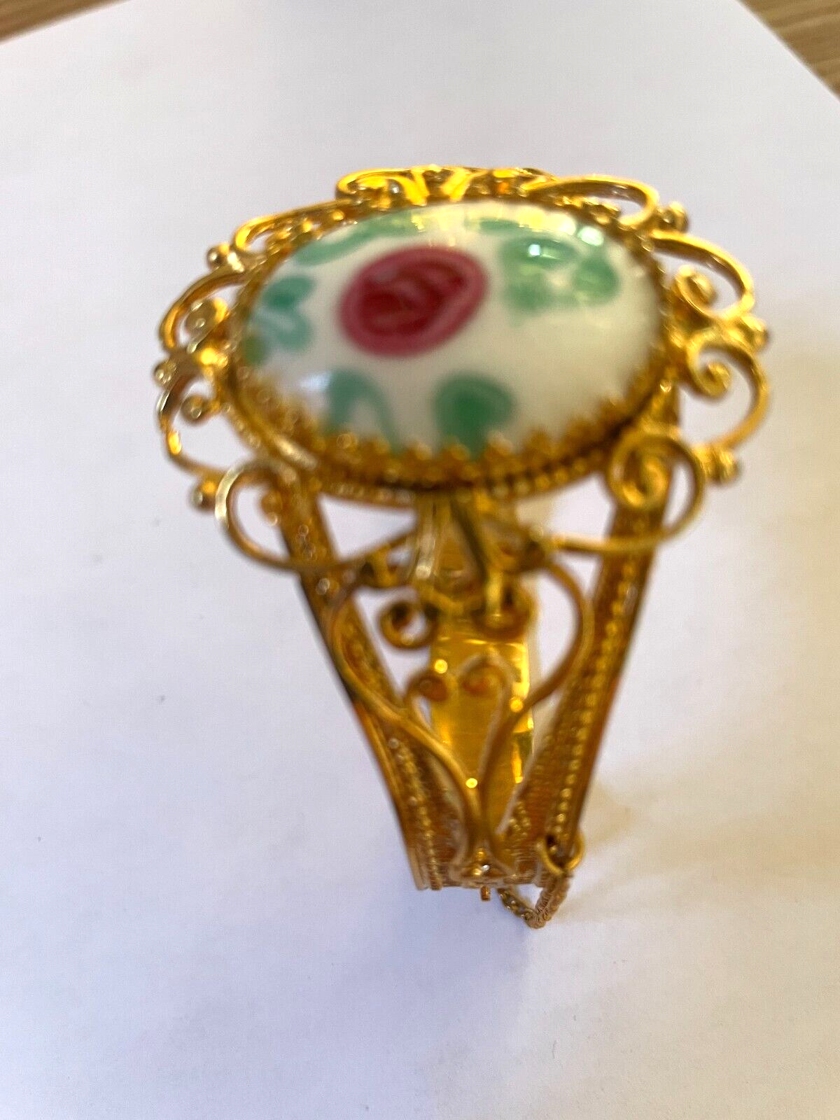 Vintage gold-tone bangle bracelet with porcelain floral cabochon and slide clasp-image