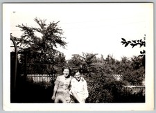 Vtg B&W Snapshot Smiling Couple Sitting Outside Garden Backyard Fence Trees